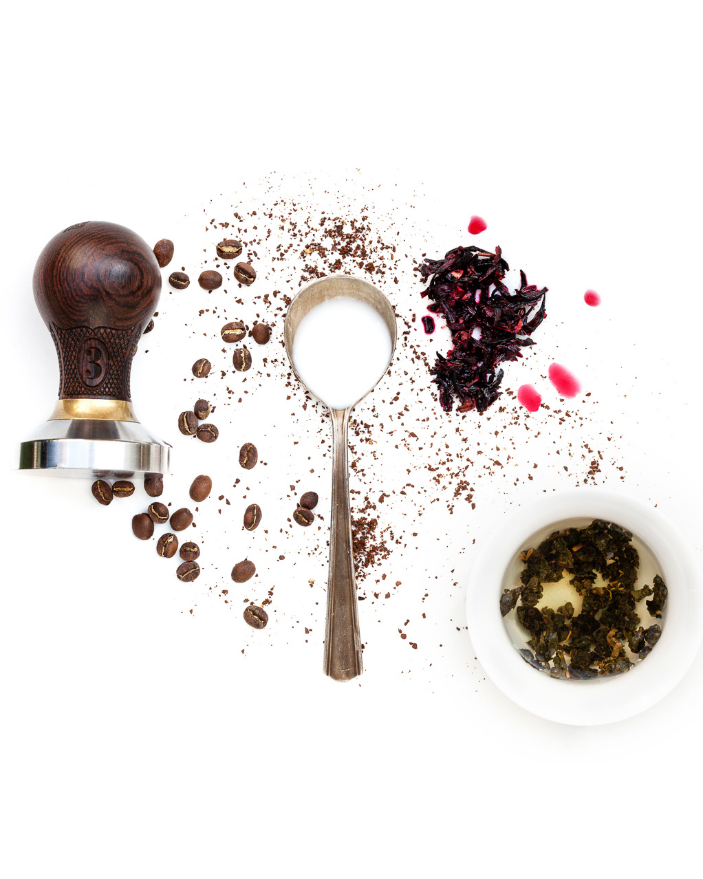 Spoonfuls of Inspiration: Dale Donchey - The Last Link Spoonful portrait of Dale Donchey titled The Last Link, featuring whole bean coffee, ground coffee, tea leaves, hibiscus flower, cream, and water alongside a 1920s silver plated cupping spoon.