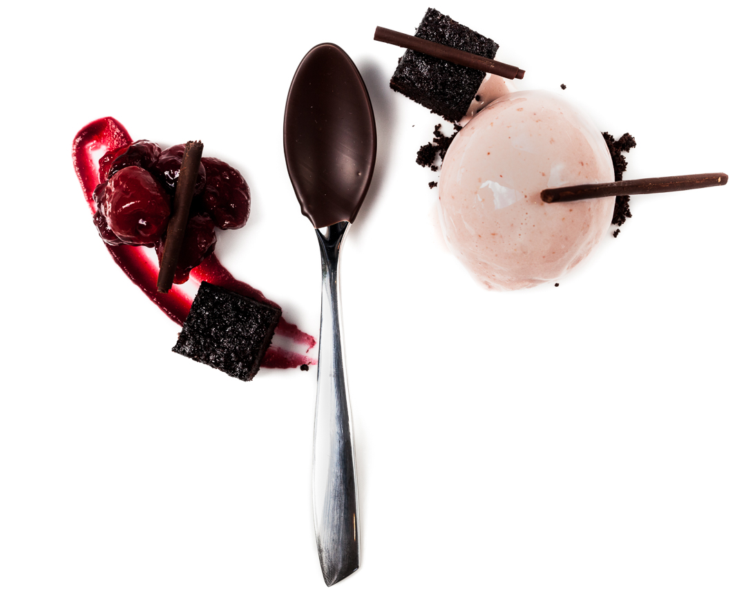 Spoonfuls of Inspiration: Joe Murphy - Black Forest Spoonful portrait of Chef Joseph Murphy titled Black Forest, featuring chocolate-dipped cherries, krisch, and devil's food cake in a specialized ice cream quenelle spoon.